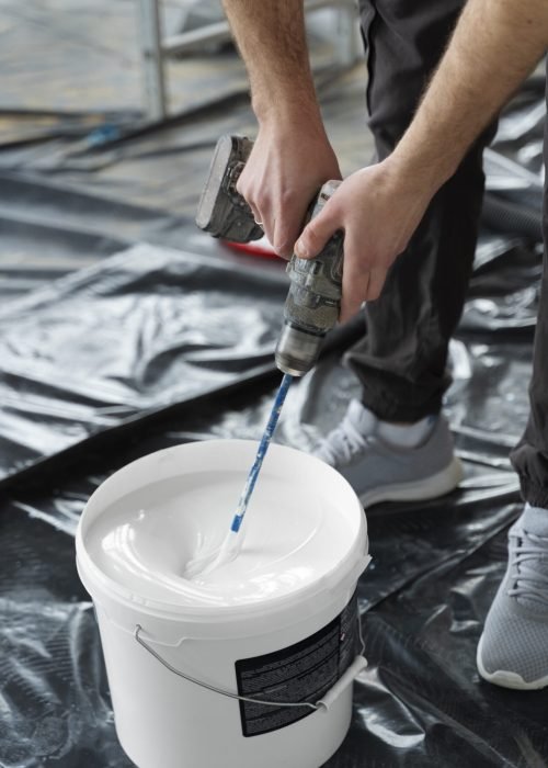 hands-mixing-paing-with-drill